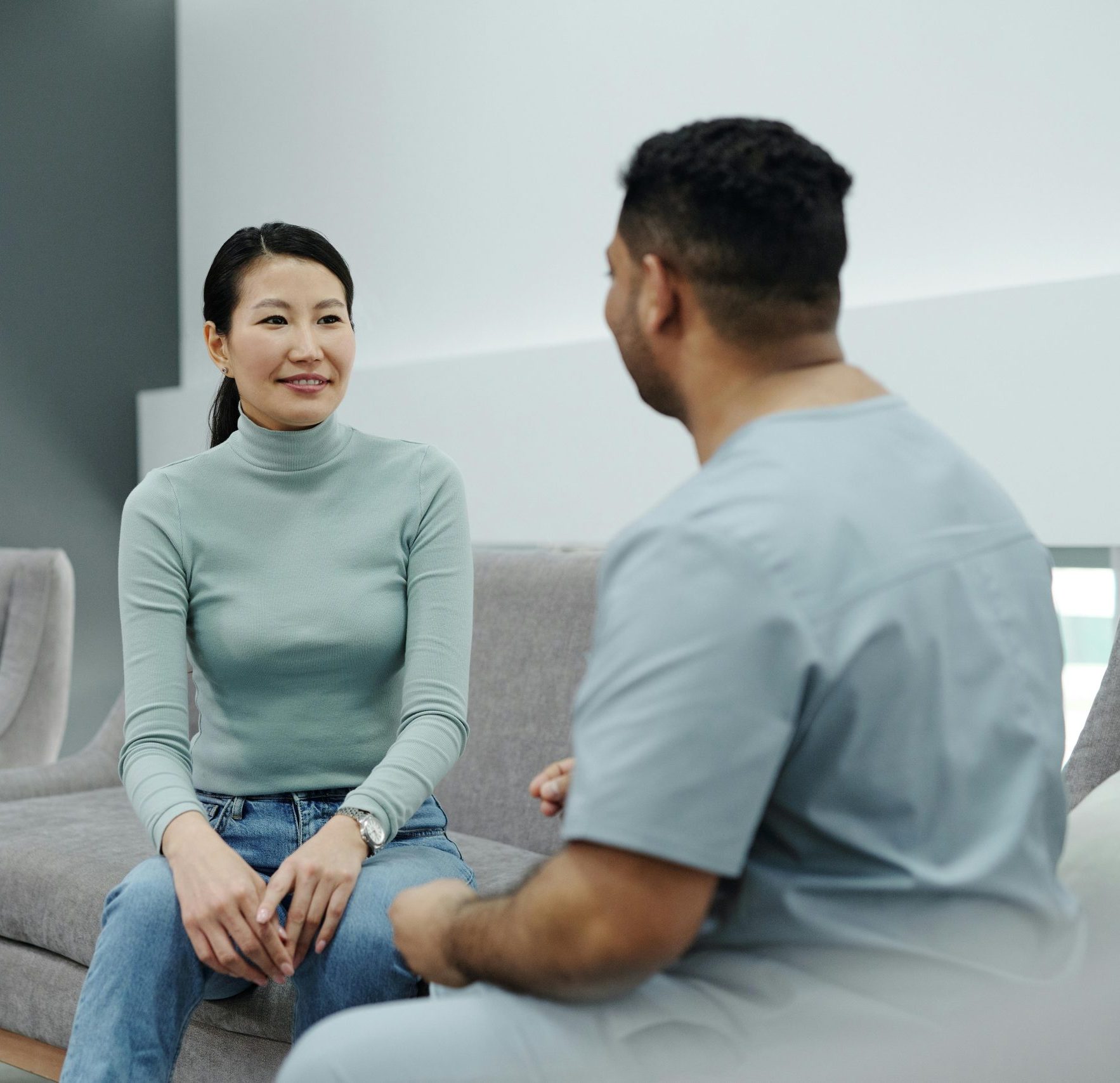 A doctor and patient having a friendly conversation in a modern clinic.